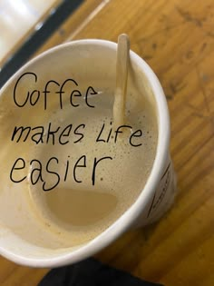 a coffee cup with writing on it and a wooden spoon in the cup that says coffee makes life easier