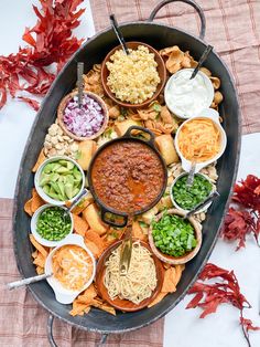 a platter filled with lots of different foods and dips on top of it