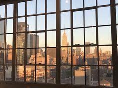 an open window with the city skyline seen through it's panes in the background