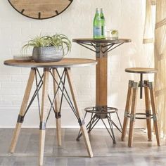 three stools and a table in front of a clock