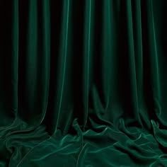 a dark green curtain with some folds on it