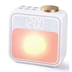 the alarm clock is white and has an orange light on it's side,