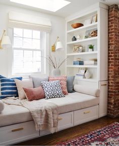 a living room filled with lots of white furniture