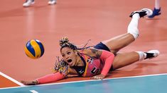 a female volleyball player dives to catch the ball during a match against spain on oct 11, 2012