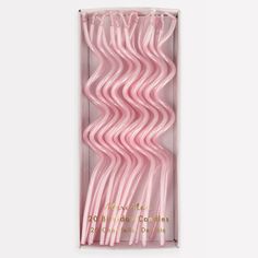 pink plastic straws in a box on a white background