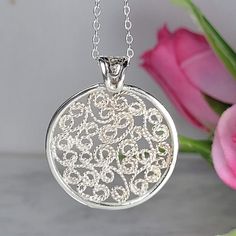 Filigree necklace  made by intricate metal work, creating a rich floral and dainty look. The round sterling silver necklace is inspired by Art nouveau jewelry combined with modern design. The silver circle necklace is a perfect meaningful gift for a beloved woman, and as a pampering gift for yourself. The necklace is very flattering, comfortable to wear as a jewel for everyday use and impressive as a jewel for a special occasion. The structure of the pendant is approximately 22mm diameter, creating an elegant and unique style. The necklace is made of 925 sterling silver by hand tools only. Each piece of jewelry is handmade to order, therefor due to the special nature of handcrafting, there may be slight differences compared to the jewelry in the photos shown. This adds to the charm and ind White Gold Necklace With Large Pendant For Anniversary, Exquisite Engraved White Gold Necklace, Engraved White Gold Flower Pendant Necklace, Handmade Pendant Necklace In White Gold, Fine Silver Circular Jewelry, Silver Circle Fine Jewelry, Silver Necklace With Large Round Pendant, Handmade White Gold Pendant Necklaces, Exquisite Round Engraved Necklaces