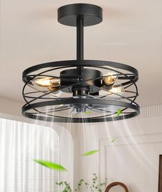 a ceiling light that is hanging from the ceiling in a room with white walls and green plants