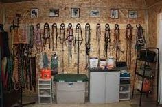 the inside of a horse stable with lots of equipment