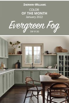 a kitchen with green cabinets and white walls, the words color of the month evergreen fog