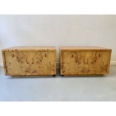 a pair of wooden boxes sitting on top of a white floor next to each other