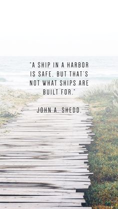 a wooden walkway leading to the ocean with a quote from john a shedd on it