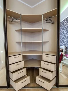 an empty closet is shown with shelves and drawers