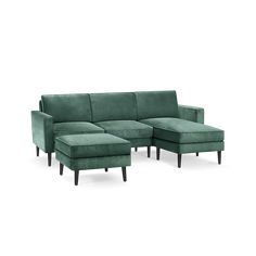 a green sectional couch with wooden legs and footrests on an isolated white background