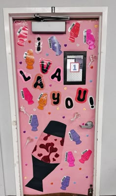 a pink door decorated with lots of different items