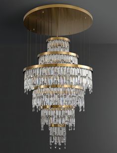 a large chandelier hanging from the ceiling in a room with dark walls and flooring