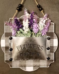 a metal sign with flowers and garden written on it