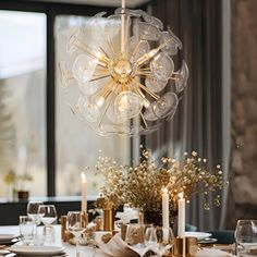 a dining room table set with candles and flowers