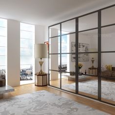 a living room filled with furniture and a large glass door that leads to a balcony