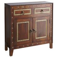 a wooden cabinet with two doors and gold trimmings