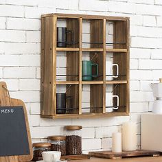 a wooden shelf with coffee mugs on it next to a chalkboard sign that says menu