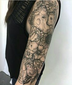 a woman's arm with an elephant and flowers tattoo on her left arm, in black and white