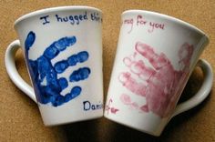 two coffee cups with handprints on them