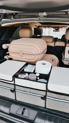 the back of a car with luggage in it's trunk and two suitcases on top