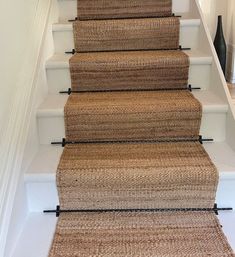 a set of stairs with carpet on the bottom and handrails to the top