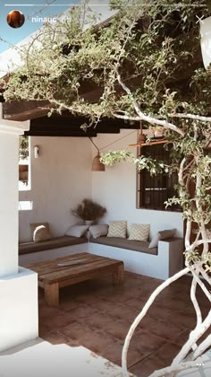 an outdoor living area with couches and tables