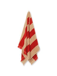 a red and white striped towel hanging on a wall