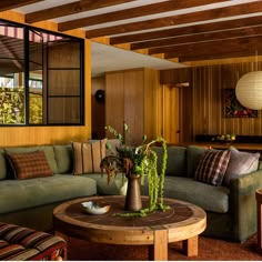 a living room filled with furniture and wooden walls