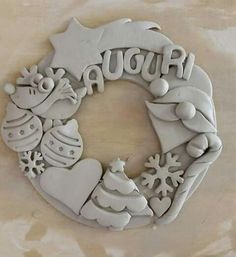 a white christmas wreath with snowflakes and other decorations