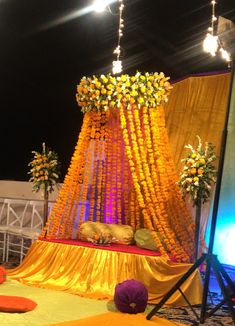 a decorated stage with yellow and orange flowers