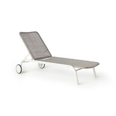 a white chaise lounge chair with wheels on the bottom and side, against a white background