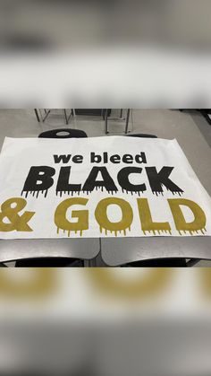 we blead black and gold sign sitting on top of a table