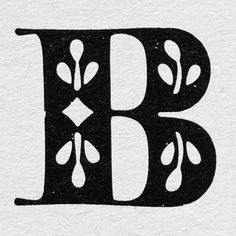 the letter b is made up of leaves and branches, with an ornate font that has been