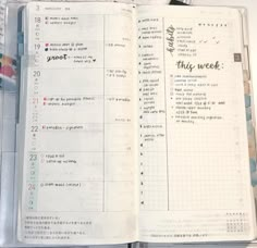 an open planner book sitting on top of a table