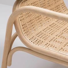 a close up of a chair made out of wood and caned with wicker