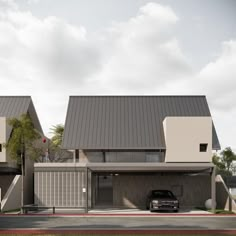 a car is parked in front of two modern houses