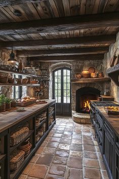 an old fashioned kitchen with stone walls and flooring is well lit by the fireplace