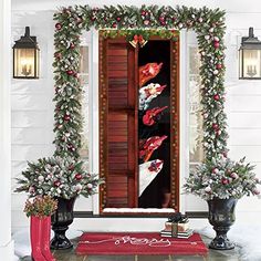 an open door decorated with christmas garland and flowers