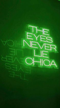 a neon sign that says the eyes never lie chicago on it's back wall