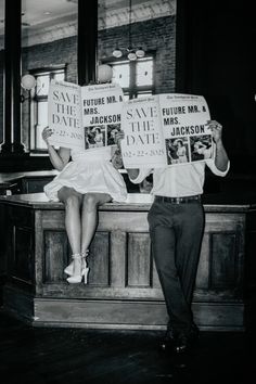 a man and woman sitting on a bench with newspapers in their hands, reading the same newspaper