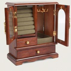 an open wooden armoire with towels and pillows on it's sides, in front of a white background