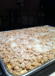 a close up of a tray of food on a stove top with white icing