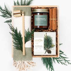 The Holiday Home box is filled with warm scents of the winter season. Woodsy notes and a natural color palette make this feel-good gift perfect for an individual or couple. Bamboo Turkish Towel in ecru and olive stripe weave. Extremely soft, highly water absorbent, soft even after repeated washes. Organic shea butter Douglas Pine soap from Lucia. Winter-scented soy candle from Calyan Wax Co. Gold Candle Snuffer Hand-tied Cinnamon Sticks. Small wooden slide-top box tied with ribbon. Textured ivor Neighbor Holiday Gifts, Christmas Gifts For Office Staff, Luxury Soap Packaging, Christmas Branding, Client Gifts Christmas, Gift Basket Christmas, Unique Homemade Gifts, Wooden Slide, Neighborhood Gifts