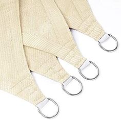 three pieces of cloth with metal hooks on them