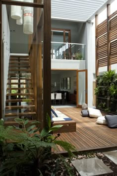 an instagram photo of a house with stairs and plants on the decking area