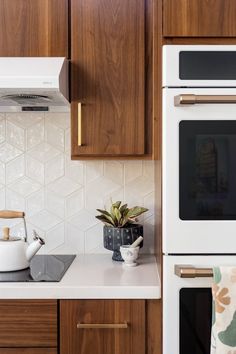 a white stove top oven sitting inside of a kitchen next to wooden cupboards and counter tops