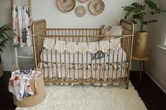 a baby crib in the corner of a room with three baskets on the wall